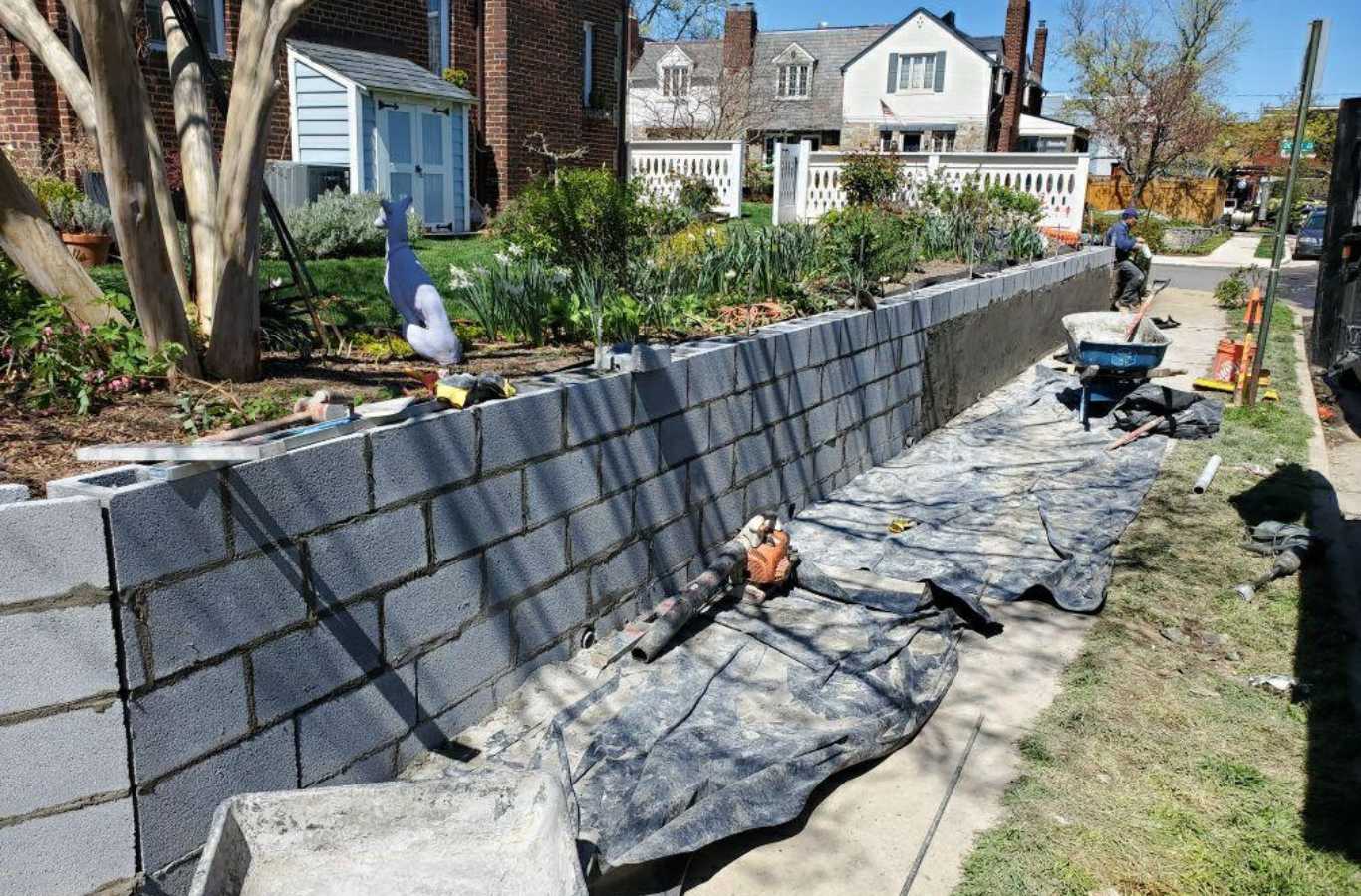 Professionals from FARE Outdoor Construction constructing a retaining wall in Hoover, AL.